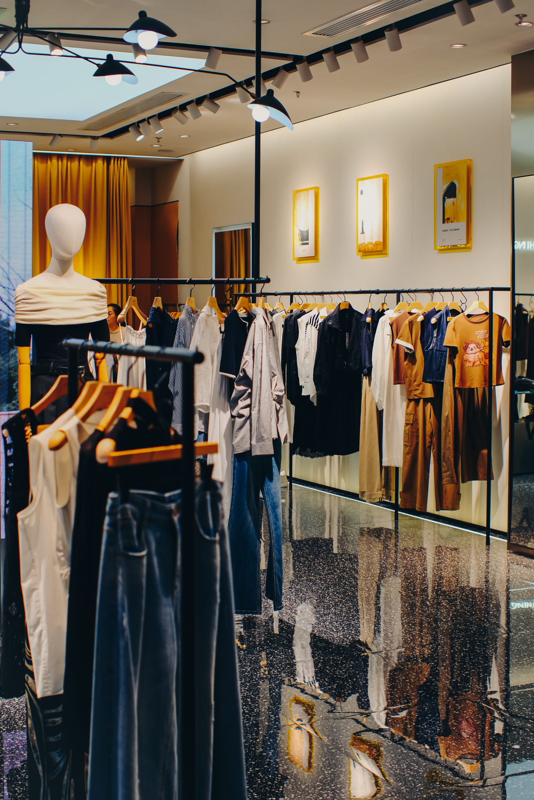 Interior of a chic fashion boutique showcasing trendy clothing displays and elegant decor.
